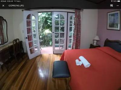 a bedroom with a red bed with white towels on it at La Bergerac Boutique Hotel in San José