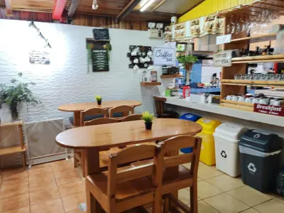 a dining room with two tables and chairs at Cabinas El Pueblo B&B Monteverde in Monteverde Costa Rica