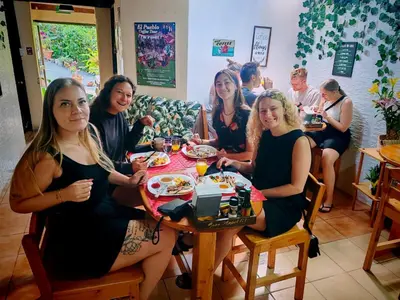 a group of women sitting at a table eating at Cabinas El Pueblo B&B Monteverde in Monteverde Costa Rica