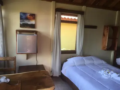 a bedroom with a bed and a window and a television at Bella Vista Lodge in Monteverde Costa Rica