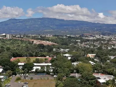 an aerial view of a city with a mountain at Boho Chic, Apart- condo cerca de SJO Intl airport in Barrial