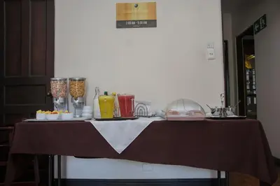 a table with some food and drinks on it at Hotel Colonial in San José