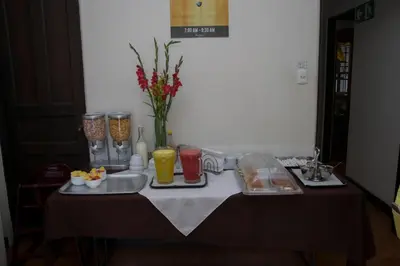 a table with plates of food and drinks on it at Hotel Colonial in San José