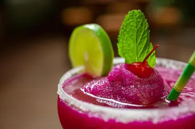 a pink drink with a strawberry and a lime at Hacienda La Pacífica Eco-Lodge in Cañas