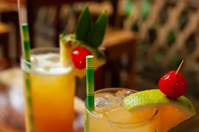 a drink with a lime and cherries in a glass at Hacienda La Pacífica Eco-Lodge in Cañas