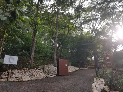 a wooden gate in the middle of a dirt road at Baliyana Lodge in San José Pinilla