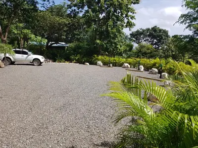 a car parked in a gravel parking lot at Baliyana Lodge in San José Pinilla
