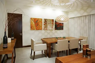 a dining room with a wooden table and chairs at El Mangroove Papagayo, Autograph Collection in Papagayo, Guanacaste
