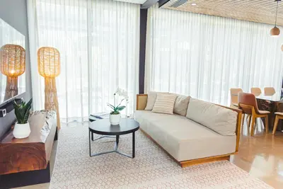 a living room with a white couch and a table at El Mangroove Papagayo, Autograph Collection in Papagayo, Guanacaste