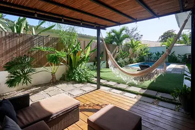 a patio with a hammock and a pool at Villa Koi ~ Brand NEW Villa ~ 2 Bedrooms with Pool in Carmen