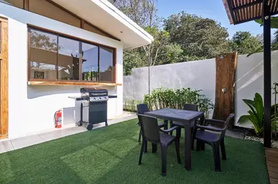 a patio with a table and chairs and a grill at Villa Akari - Brand new 2bedrooms Villa with Pool in Carmen