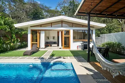 a house with a swimming pool next to a house at Villa Akari - Brand new 2bedrooms Villa with Pool in Carmen