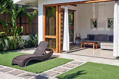 a living room with a couch and a green rug at Villa Akari - Brand new 2bedrooms Villa with Pool in Carmen