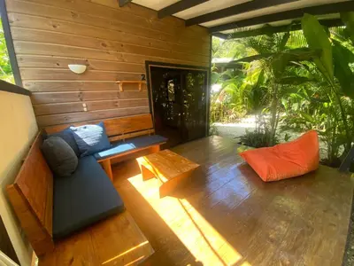 a living room with a couch and a table at Santeria Lodge in Santa Teresa Beach