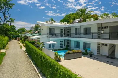an exterior view of a house with a swimming pool at HOTEL MARINO BALLENA in Uvita
