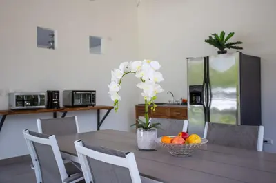 a table with a bowl of fruit and a refrigerator at HOTEL MARINO BALLENA in Uvita