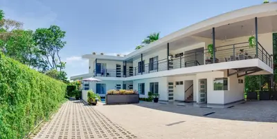 an exterior view of a house with a balcony at HOTEL MARINO BALLENA in Uvita