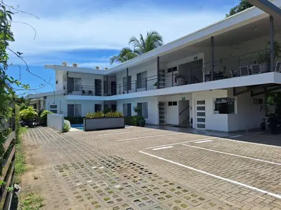 a building with a tennis court in front of it at HOTEL MARINO BALLENA in Uvita