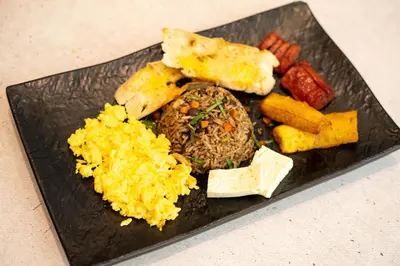 a plate of food with rice and different types of food at Hotel Cultura Plaza in San José