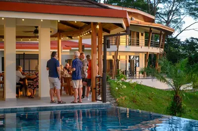a group of people standing outside of a house at Lapazul Boutique Hotel in Savegre