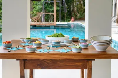 a table with bowls and plates of food on it at Lapazul Boutique Hotel in Savegre