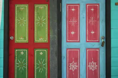 two red and green doors with snowflakes on them at Cabinas Tortuguero in Tortuguero