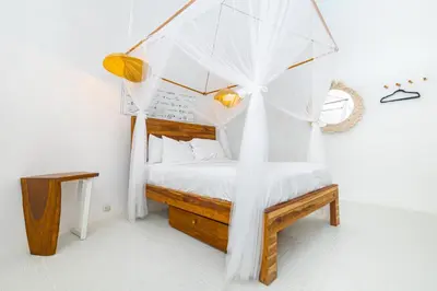 a bedroom with a bed with a canopy at Igloo Beach Lodge in Manuel Antonio