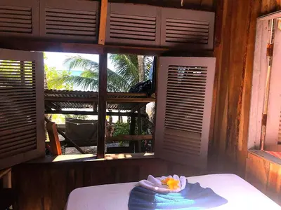 a room with a bed with a view of a window at Surfhost in Garza