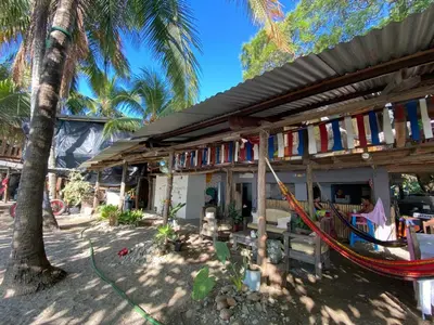 a house with a hammock in front of it at Surfhost in Garza