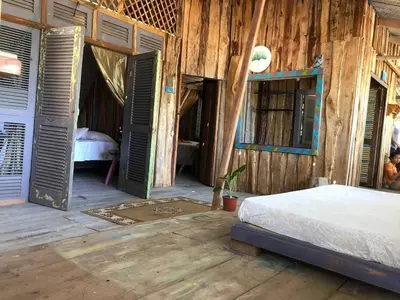 a bedroom with a bed and open doors at Surfhost in Garza