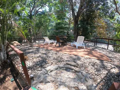 a patio with chairs and a table and a fence at Hotel Poza Blanca Lodge in San Mateo