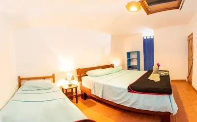 a bedroom with two beds and a window at Pochote Lodge in Hacienda Guayabo