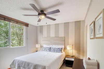 a bedroom with a bed with a ceiling fan at Costa Linda 7-13 in Jacó