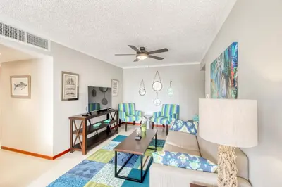 a living room with a couch and a table at Costa Linda 7-13 in Jacó