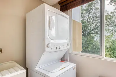 a white refrigerator in a kitchen with a window at Costa Linda 7-13 in Jacó