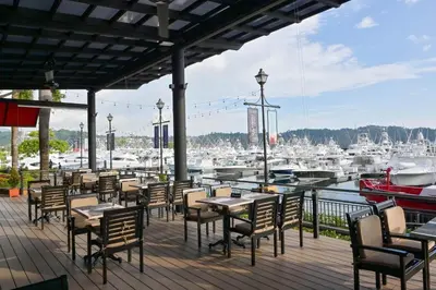 a patio with tables and chairs and a marina at AltaVista 5A 3 bdr Ocean View in Los Suenos in Herradura