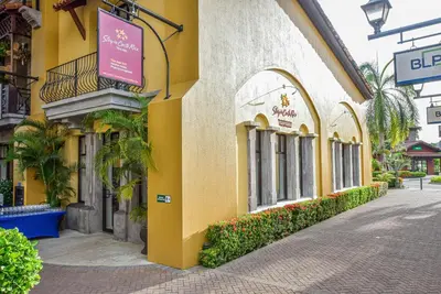 a yellow building with a sign on the side of it at AltaVista 5A 3 bdr Ocean View in Los Suenos in Herradura