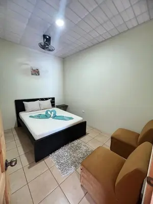 a bedroom with a bed and a couch in it at Los Sueños RyG 3 in Quepos