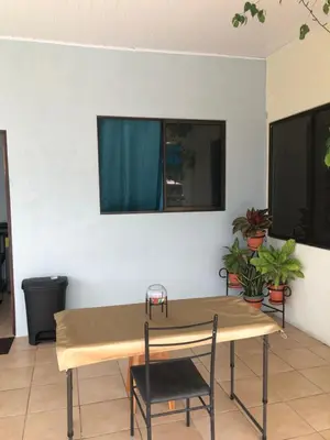 a table and chairs in a room with plants at Los Sueños RyG 3 in Quepos
