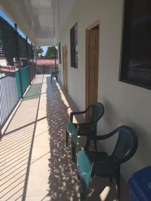 two chairs sitting on the porch of a house at Los Sueños RyG 3 in Quepos