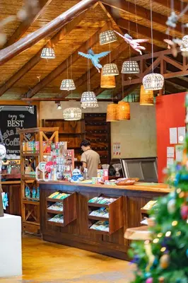 a man standing at a counter in a store at Lost Iguana Resort and Spa in Fortuna