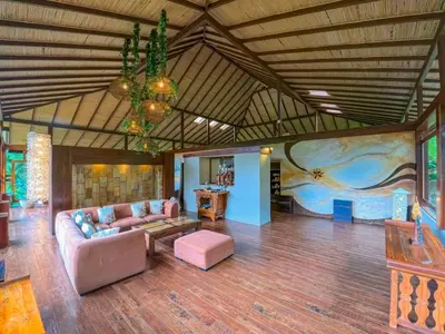 a large living room with a couch and a table at Lost Iguana Resort and Spa in Fortuna