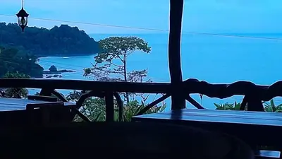 a table with a view of the ocean from a balcony at Bella Vista Corcovado in Drake