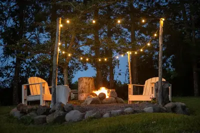 two chairs and a fire pit in a yard at night at Country house, Cozy Fireplace and an amazing view in Cartago