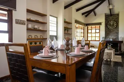 a dining room with a table with pink napkins on it at Country house, Cozy Fireplace and an amazing view in Cartago