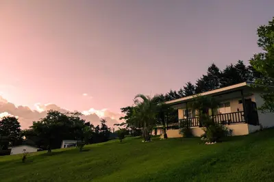 a house on a hill with a green field at Country house, Cozy Fireplace and an amazing view in Cartago