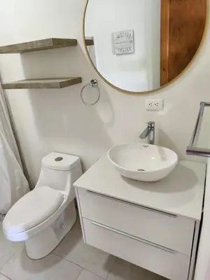a bathroom with a white toilet and a mirror at Country house, Cozy Fireplace and an amazing view in Cartago