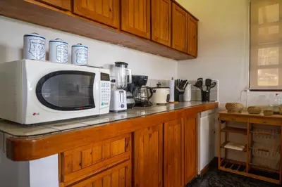 a microwave sitting on top of a counter in a kitchen at Country house, Cozy Fireplace and an amazing view in Cartago