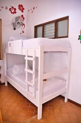 a white bunk bed in a room at Samara Pacific Lodge in Sámara