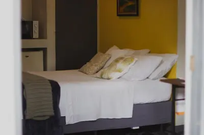 a bedroom with a bed with white sheets and pillows at blanc haus in Grecia